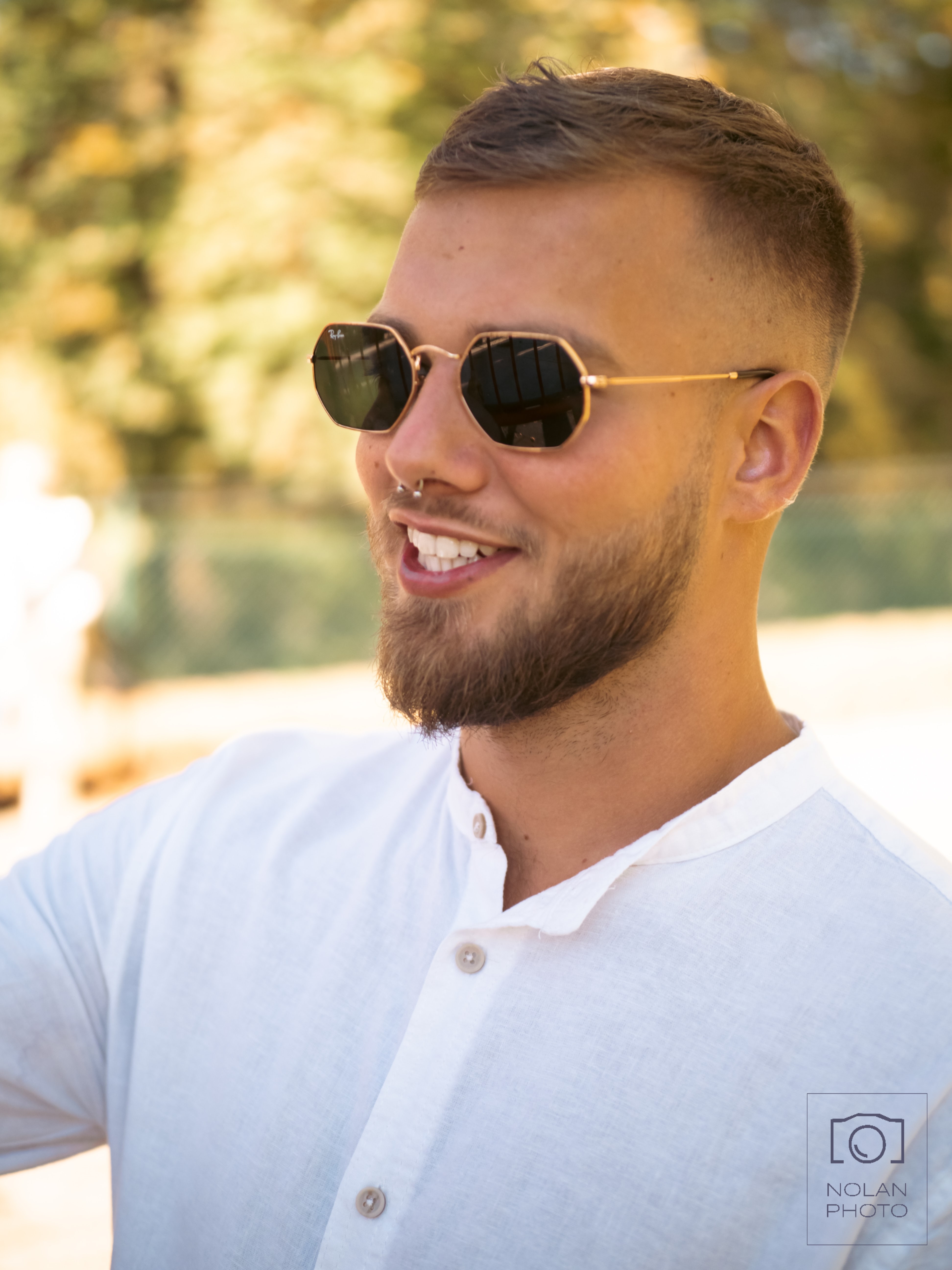 A Portrait of a Guy, wearing a white shirt and funky glasses